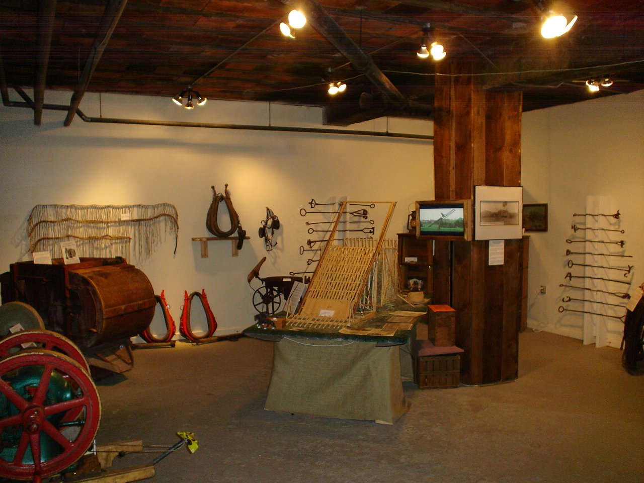 History museum gallery displaying agricultural artifacts, harnesses, and tools