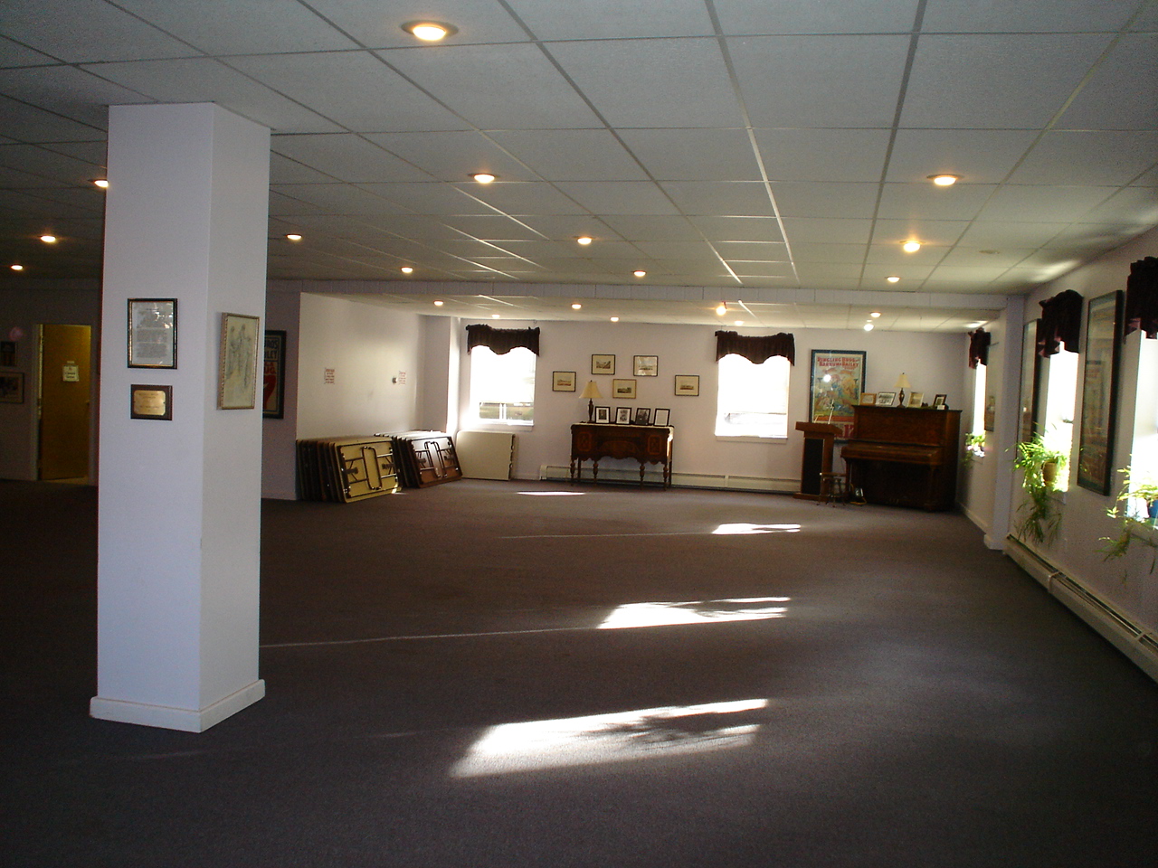 The museum's meeting room set up with tables and seating